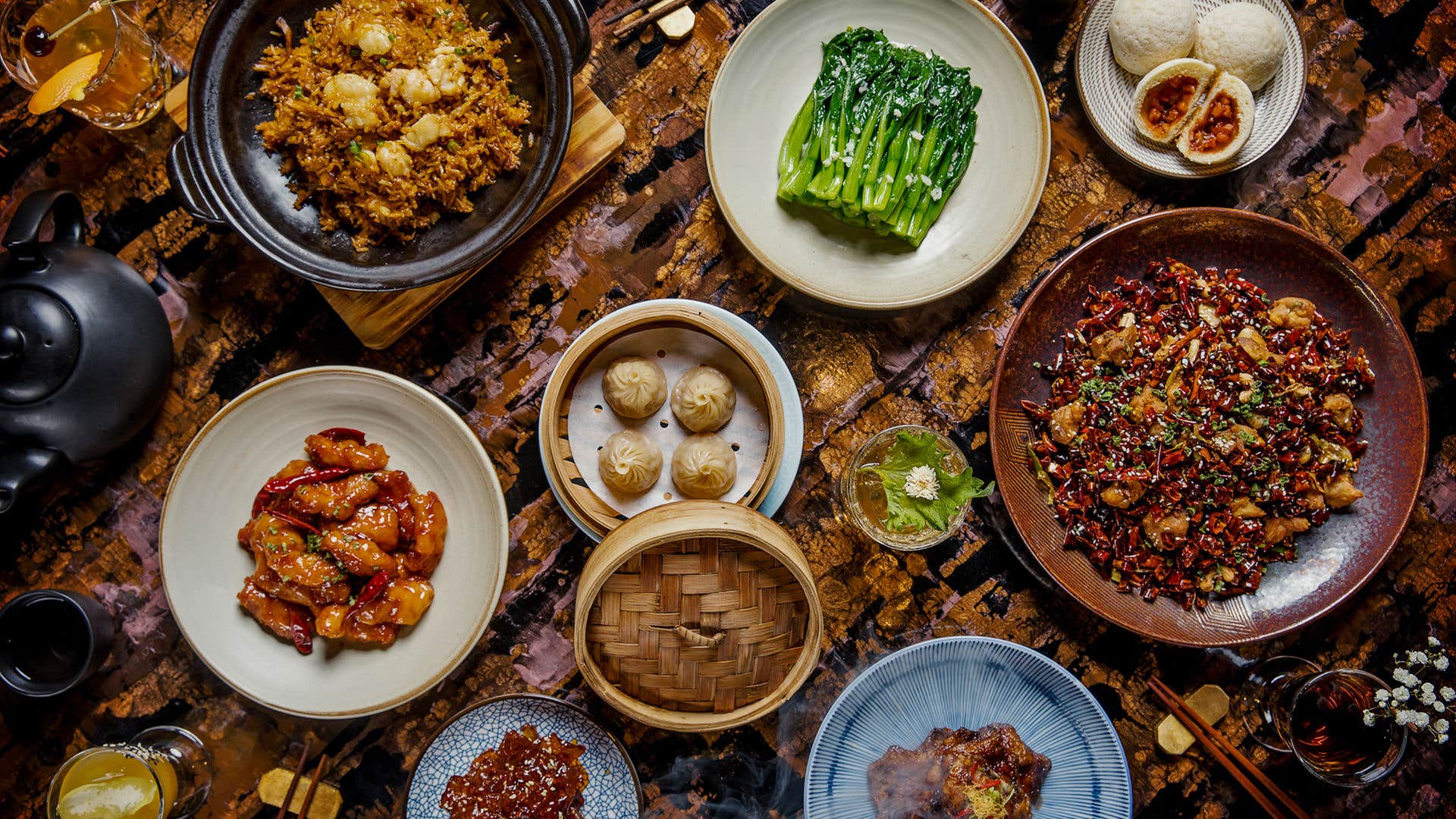 8 plates of asian style food on a table.